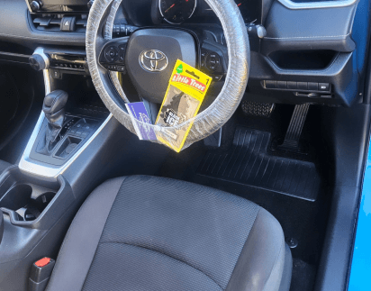 Detailed Toyota cabin with a protected steering wheel and vacuumed floor mats