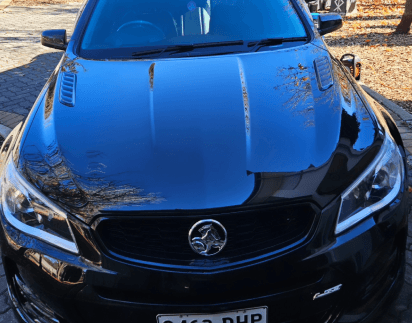 Mirror-gloss black bonnet after a cut and polish paint correction