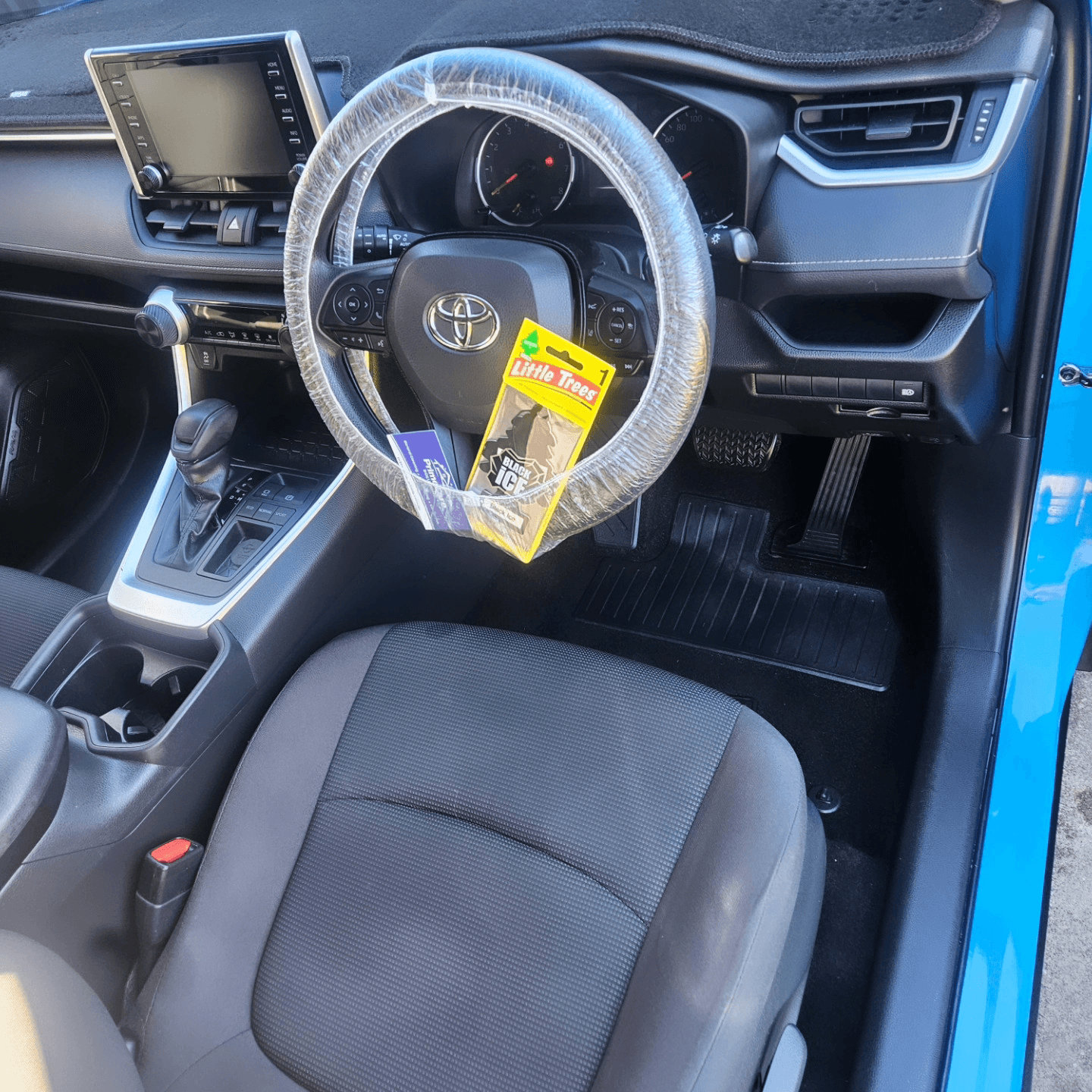 Freshly detailed Toyota RAV4 cabin with a protective steering wheel cover fitted