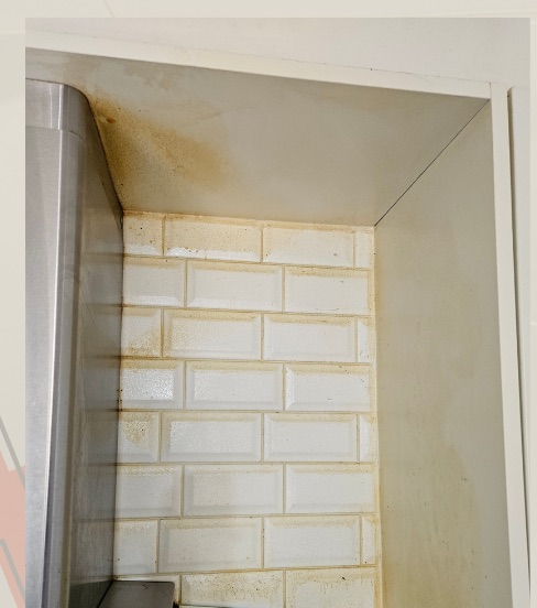 Stained tiled corner before cleaning
