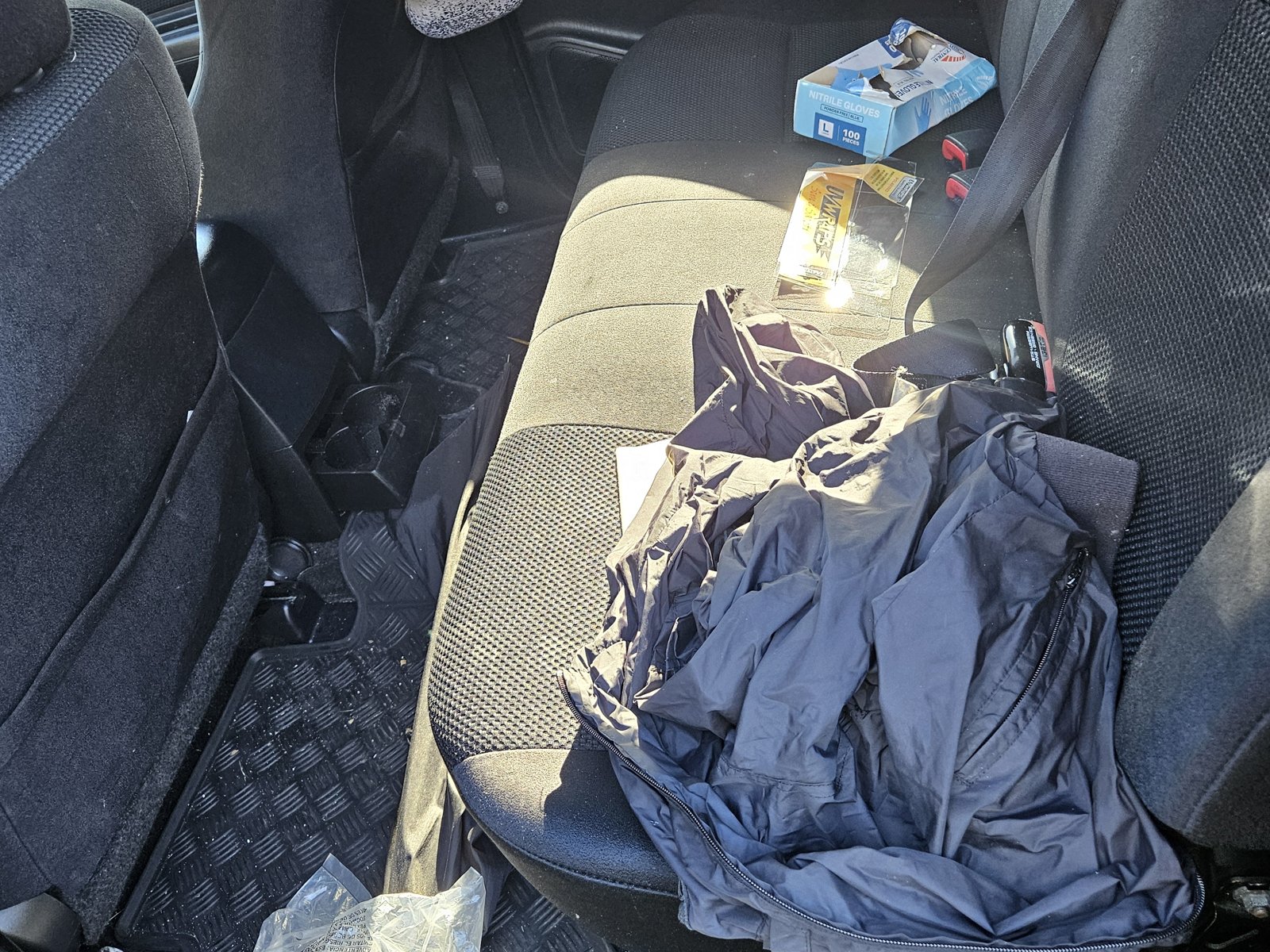 Cluttered rear seats before cleaning