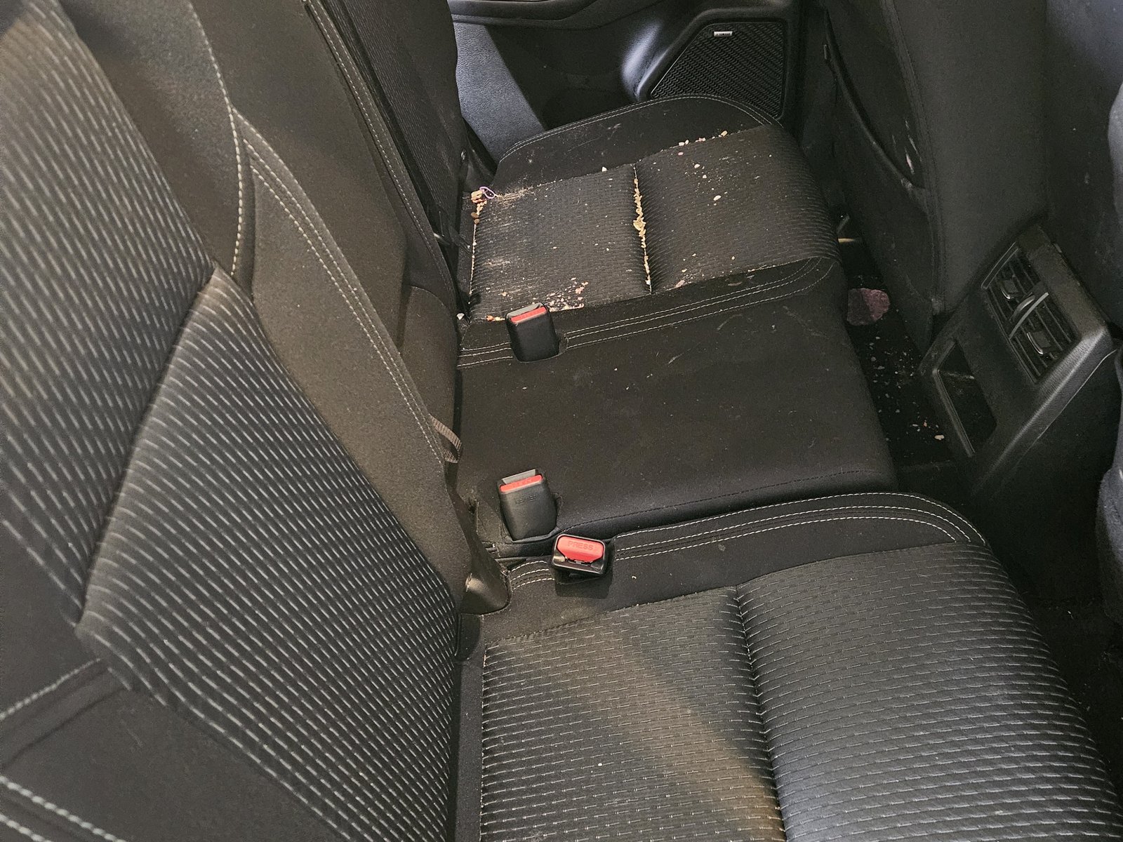 Crumb-covered rear bench before steam clean