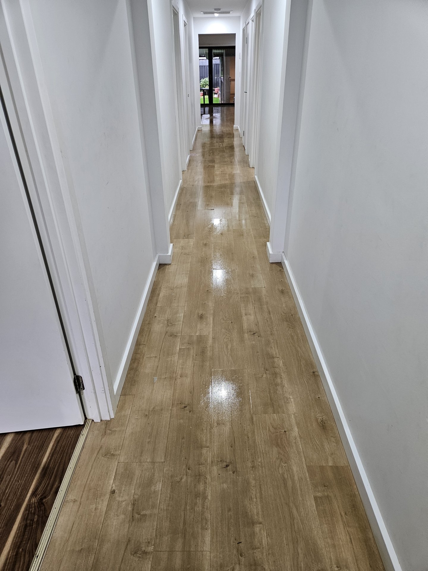 Polished timber hallway floor after cleaning