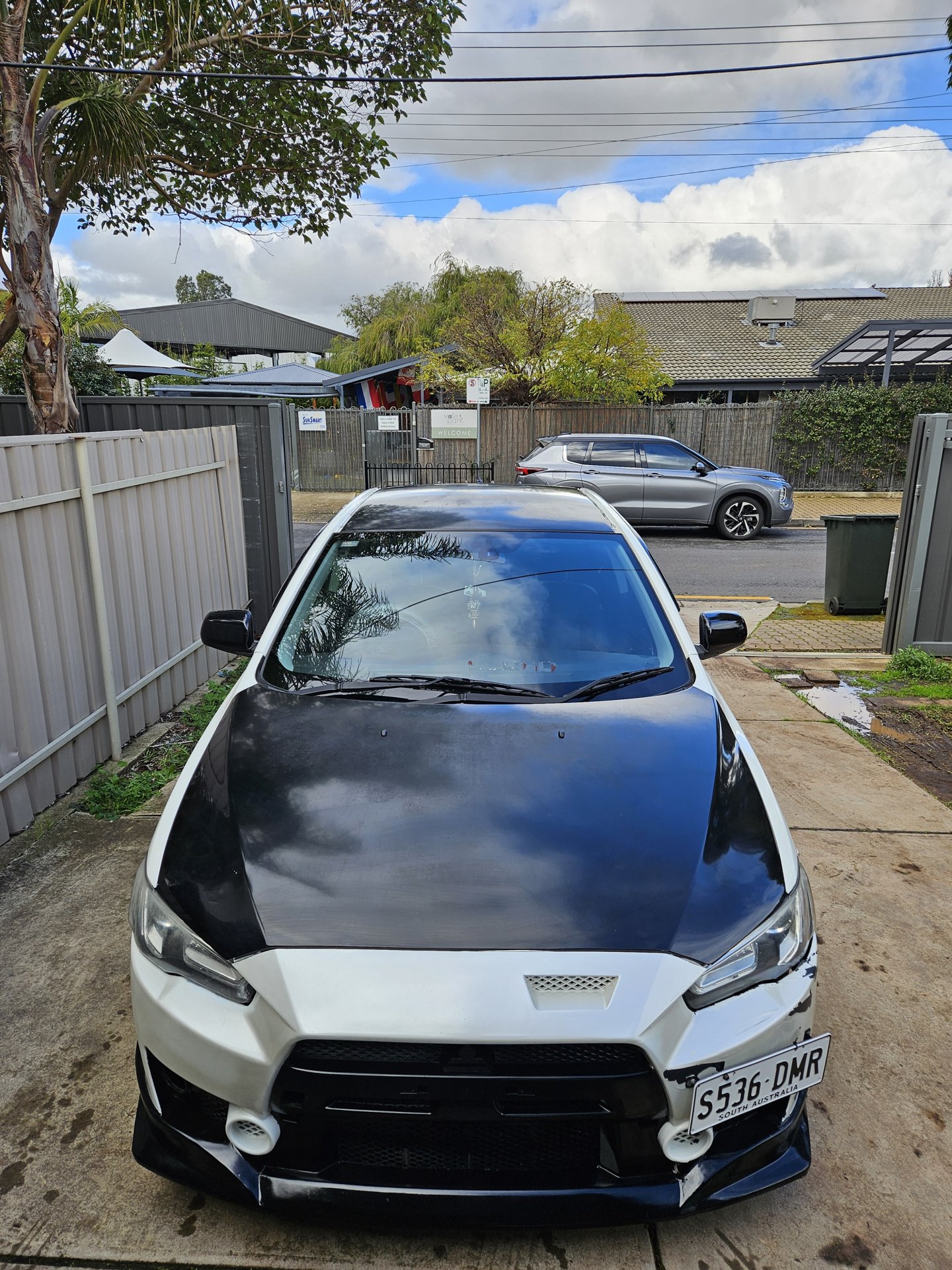 White performance sedan with carbon bonnet after detailing